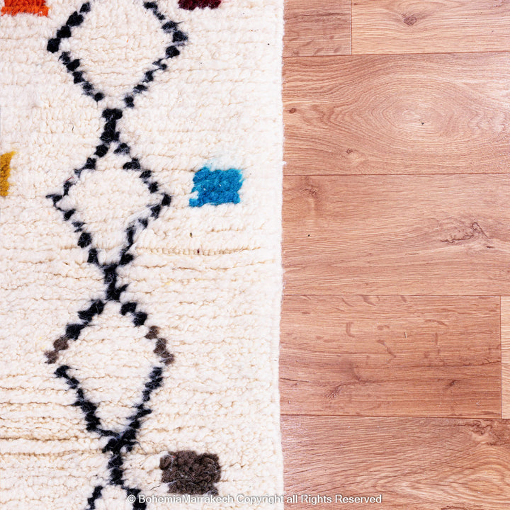 Abstract multicolored Azilal Moroccan rug with bold orange and yellow Berber motifs on wool background – handmade boho carpet