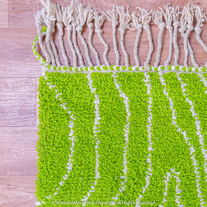 Green Moroccan wool rug with organic line patterns, handmade by Berber artisans