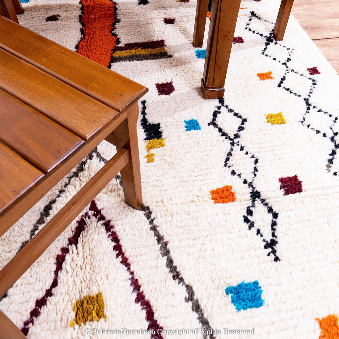 Abstract multicolored Azilal Moroccan rug with bold orange and yellow Berber motifs on wool background – handmade boho carpet