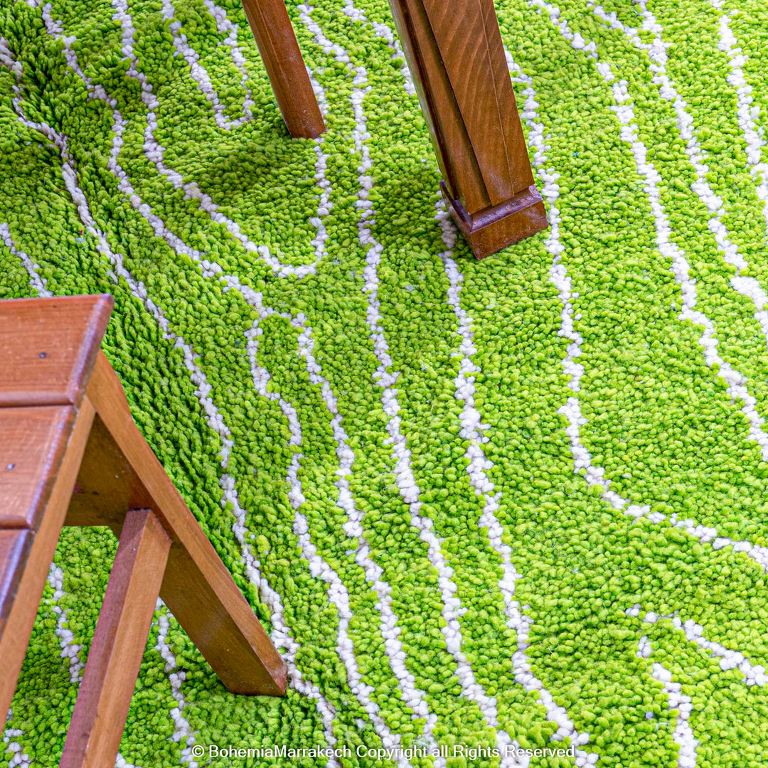 Green Moroccan wool rug with organic line patterns, handmade by Berber artisans