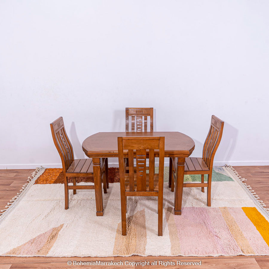 Handmade colorful striped Moroccan rug under wooden dining table set