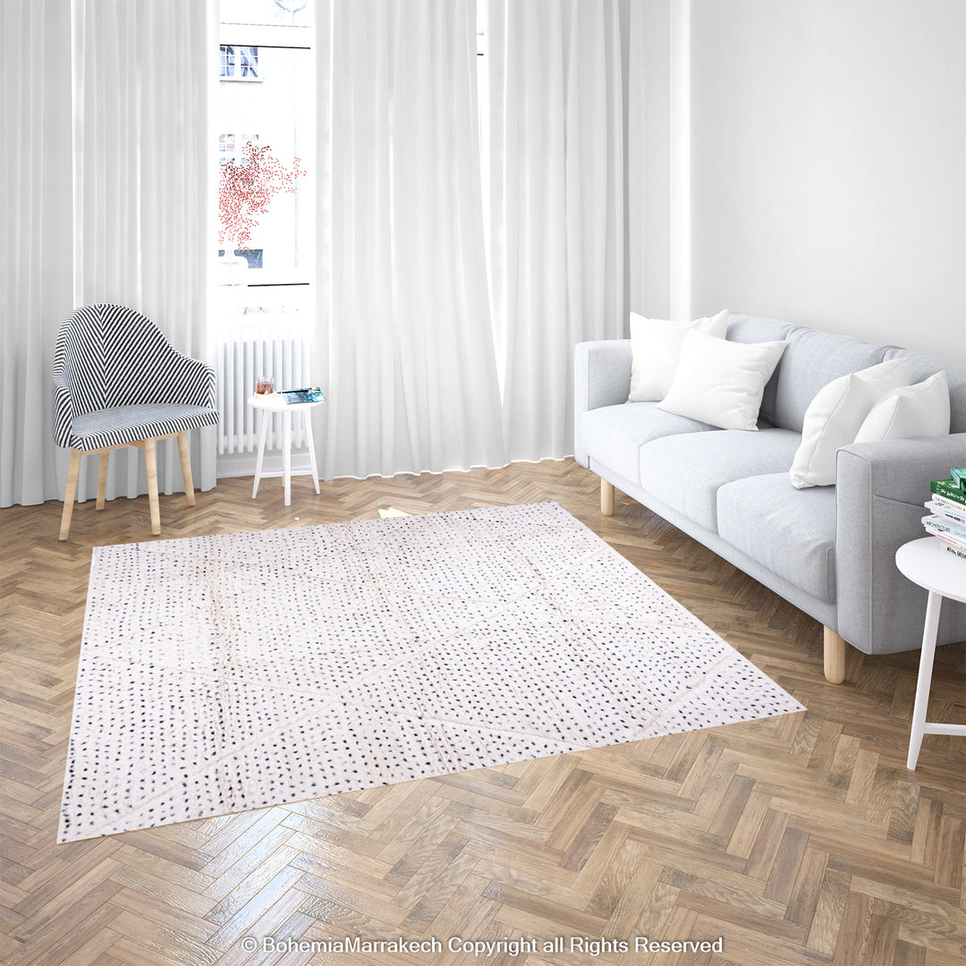 White Moroccan rug with black dots and diamond patterns in a bright living room, perfect for minimalist and boho interiors.