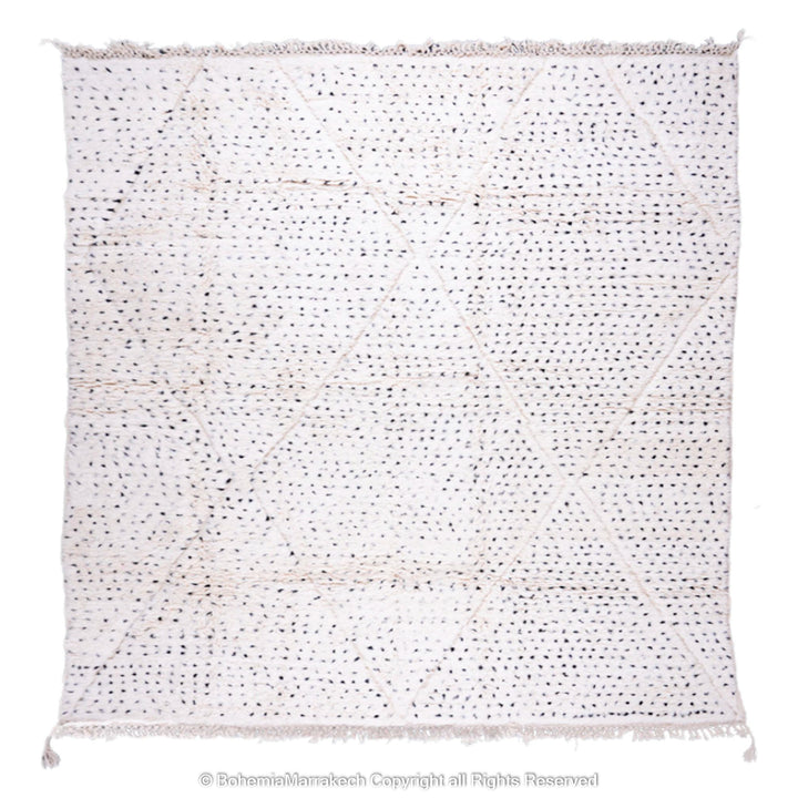 White Moroccan Berber rug with black dots and diamond pattern, handcrafted from natural wool, ideal for minimalist and boho interiors.