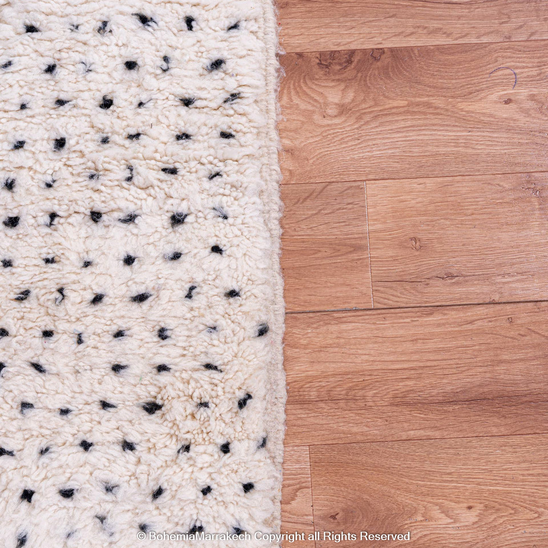 White Moroccan Berber rug with black dots on natural wool, perfect for minimalist and boho interiors.