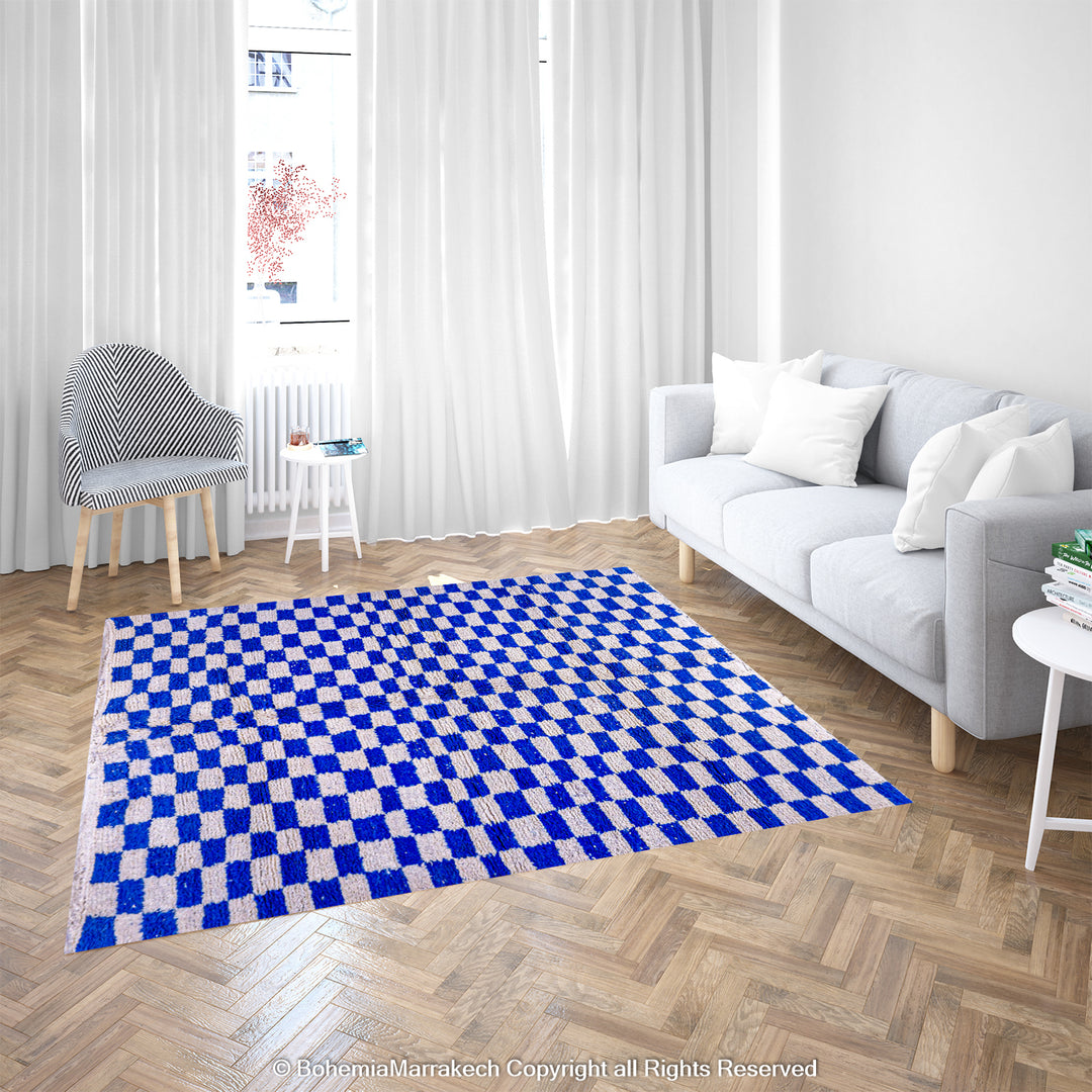 Blue and white checkered Moroccan wool rug in a modern living room, showcasing traditional Berber craftsmanship. Perfect for cozy interiors.