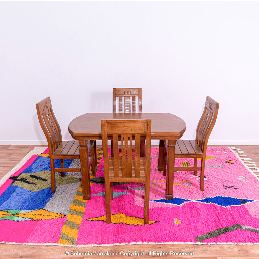 Handmade pink Moroccan rug with multicolor tribal geometric motifs, crafted in wool by Berber artisans