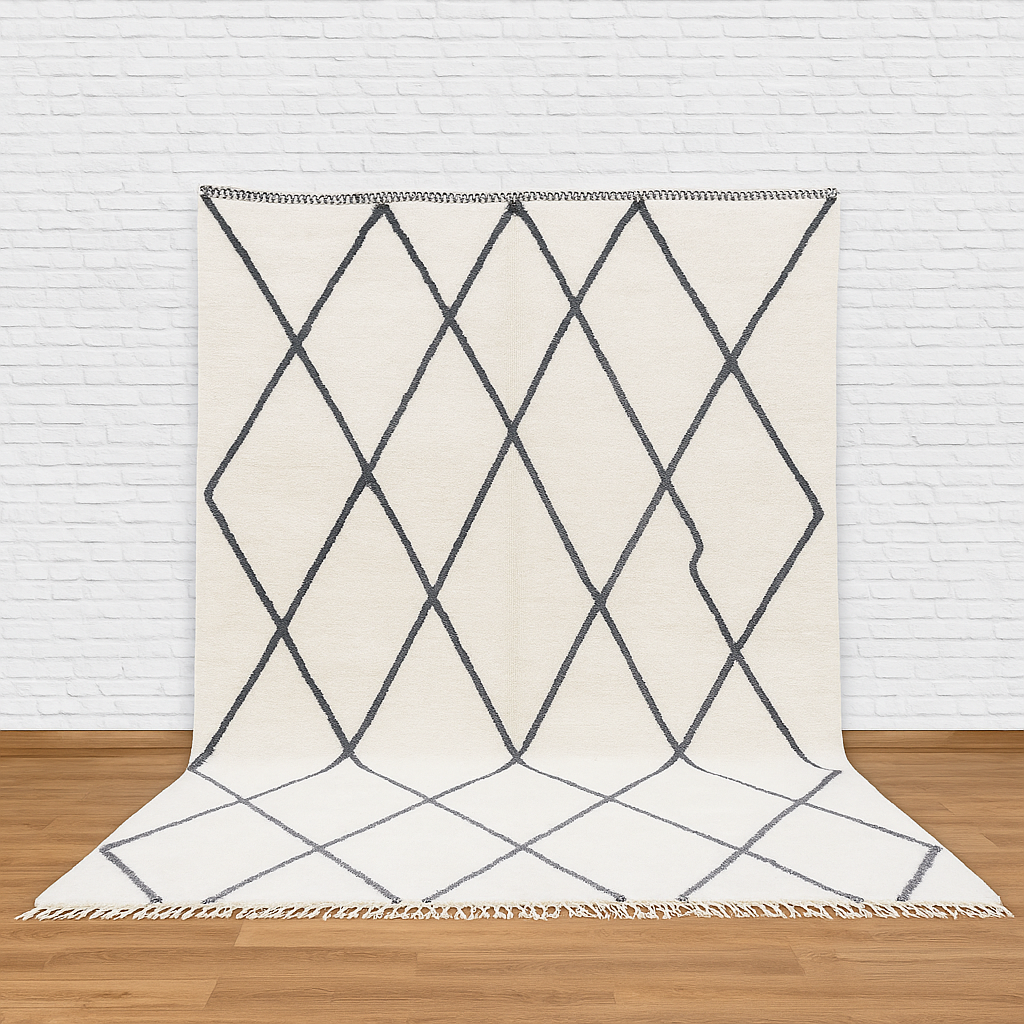 Geometric patterned rug on a wooden floor with a white brick wall background