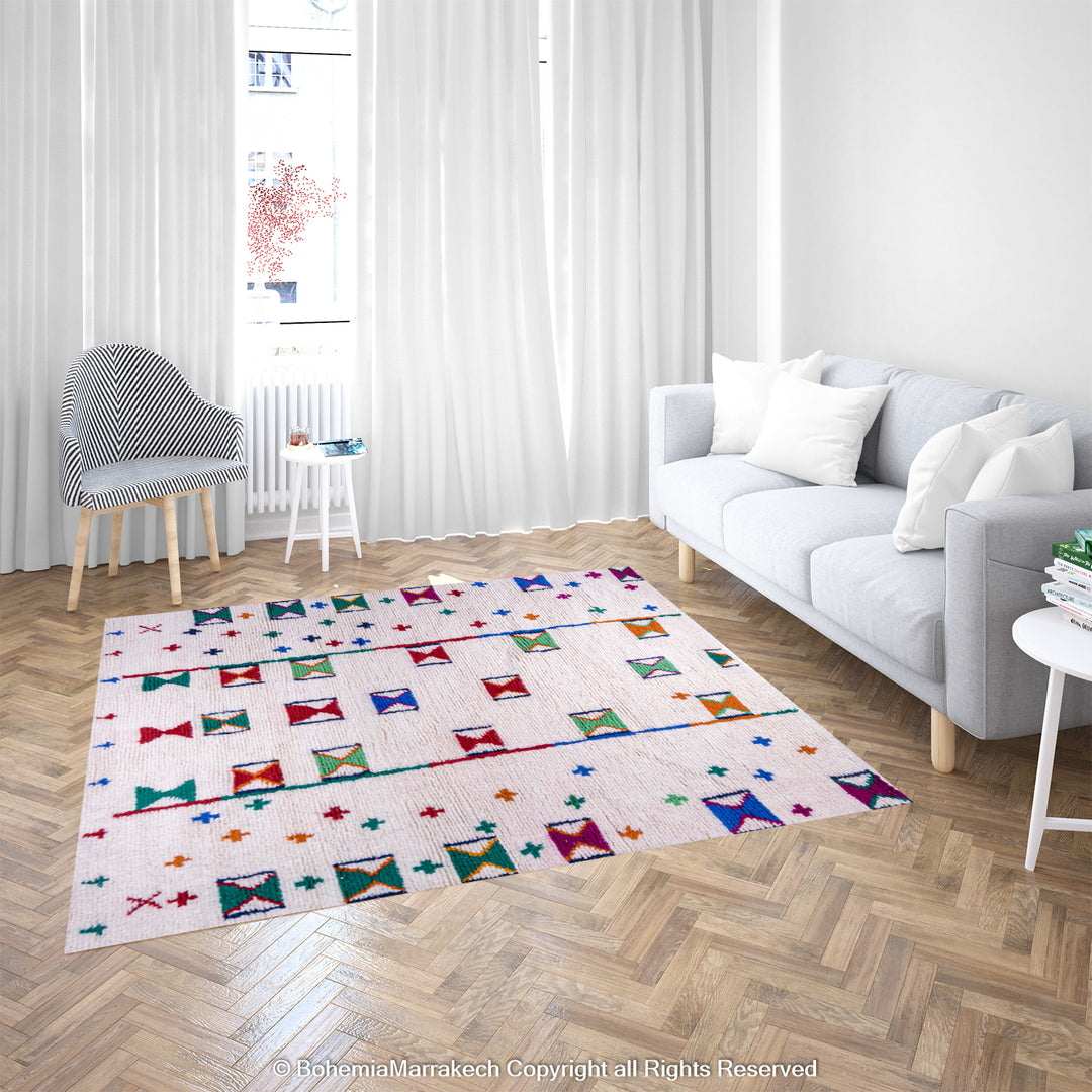 Colorful Moroccan Berber rug with traditional X and cross symbols on an ivory base in a bright, modern living room setting.