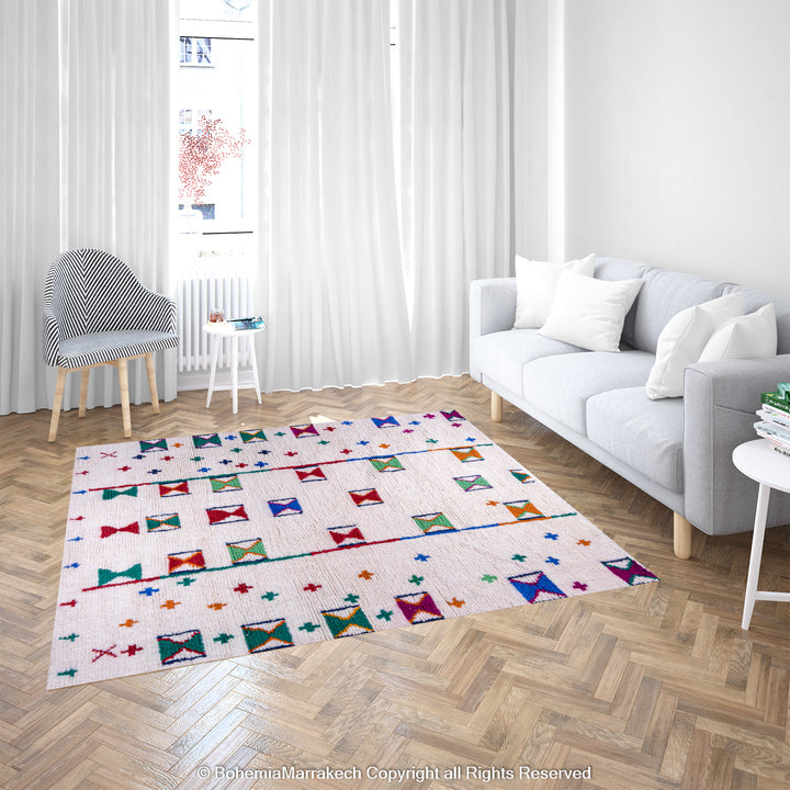 Colorful Moroccan Berber rug with traditional X and cross symbols on an ivory base in a bright, modern living room setting.