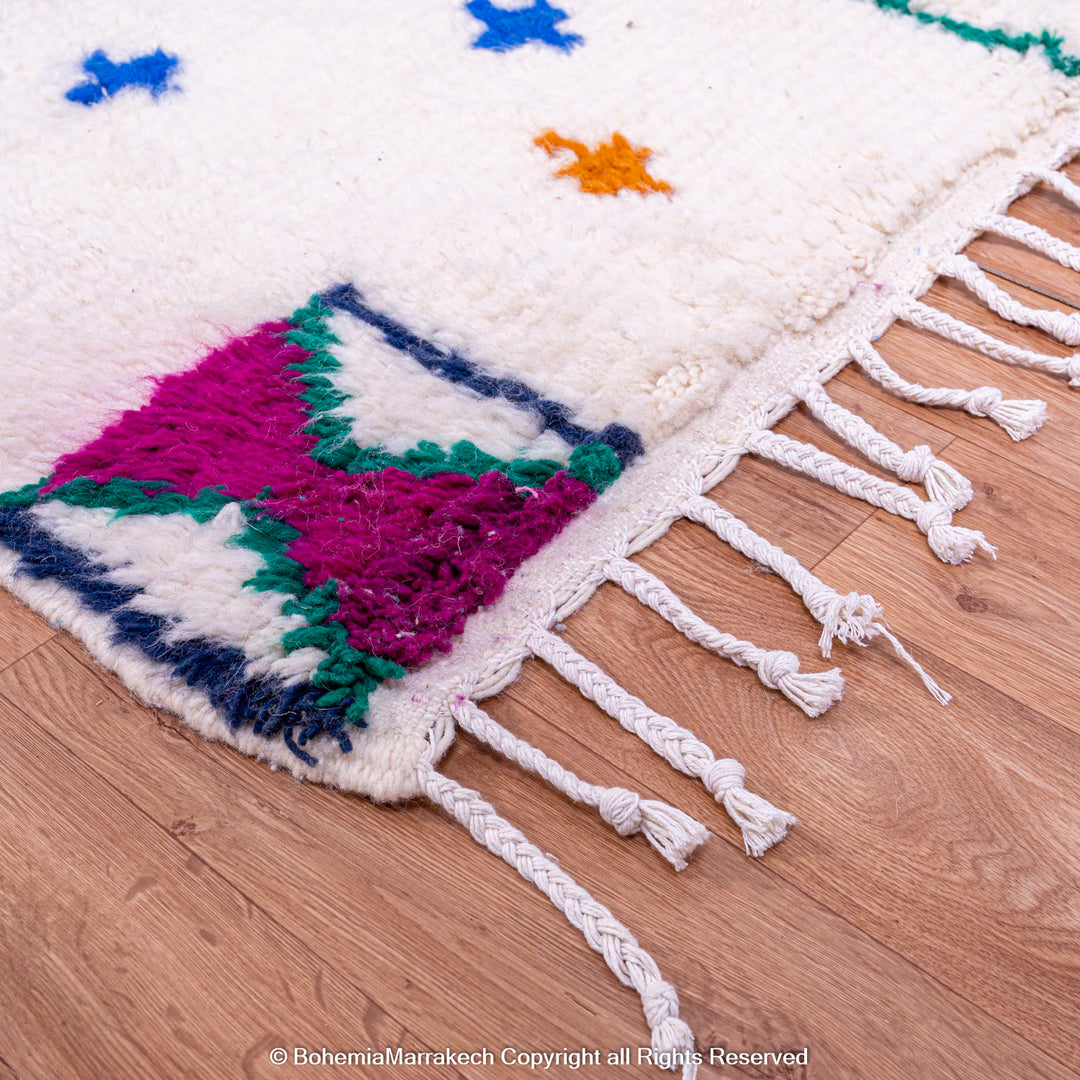 Colorful Moroccan rug with Berber X and cross symbols, featuring vibrant geometric patterns and handwoven wool. Perfect for artistic interiors.