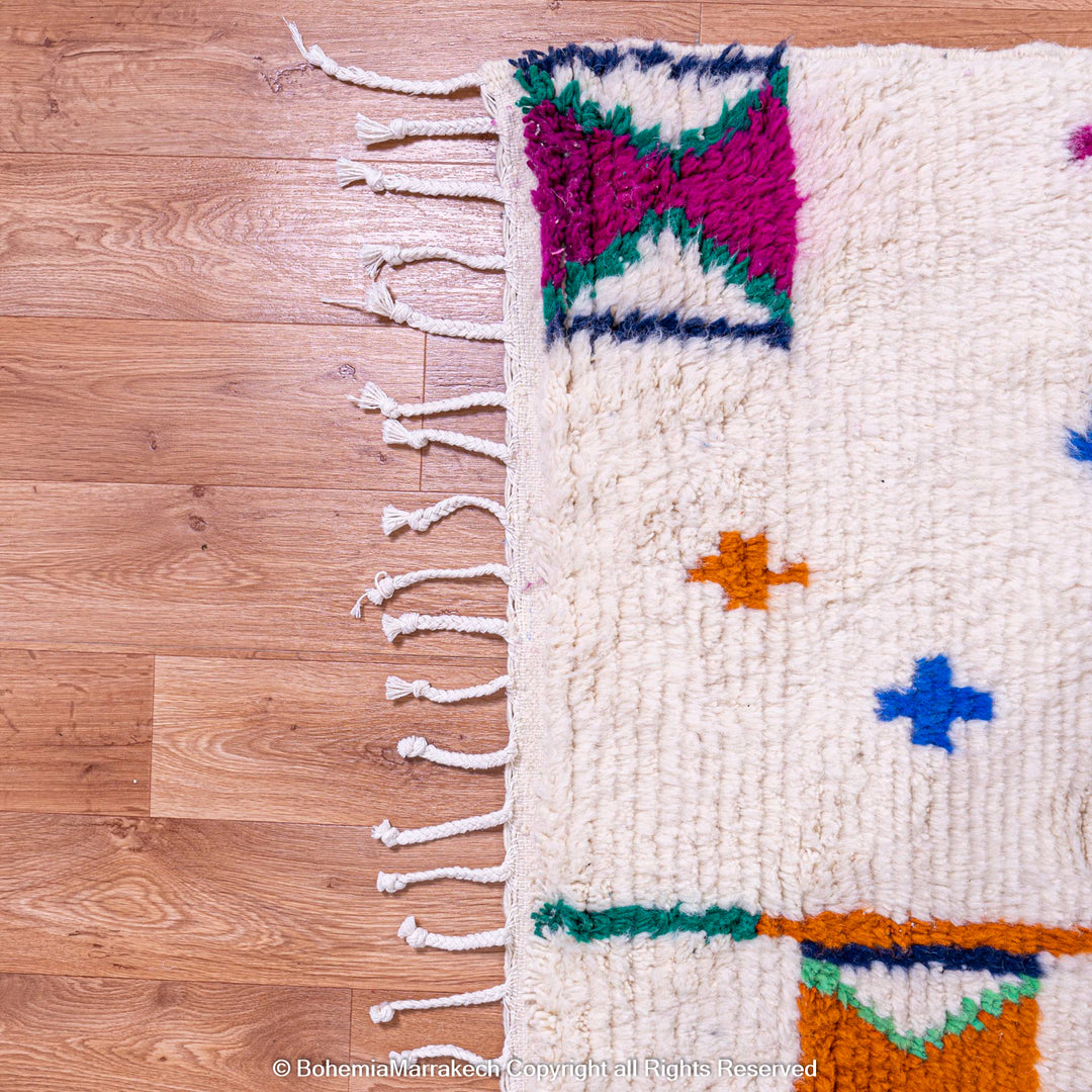 Colorful Moroccan Berber rug with X and cross symbols on ivory background