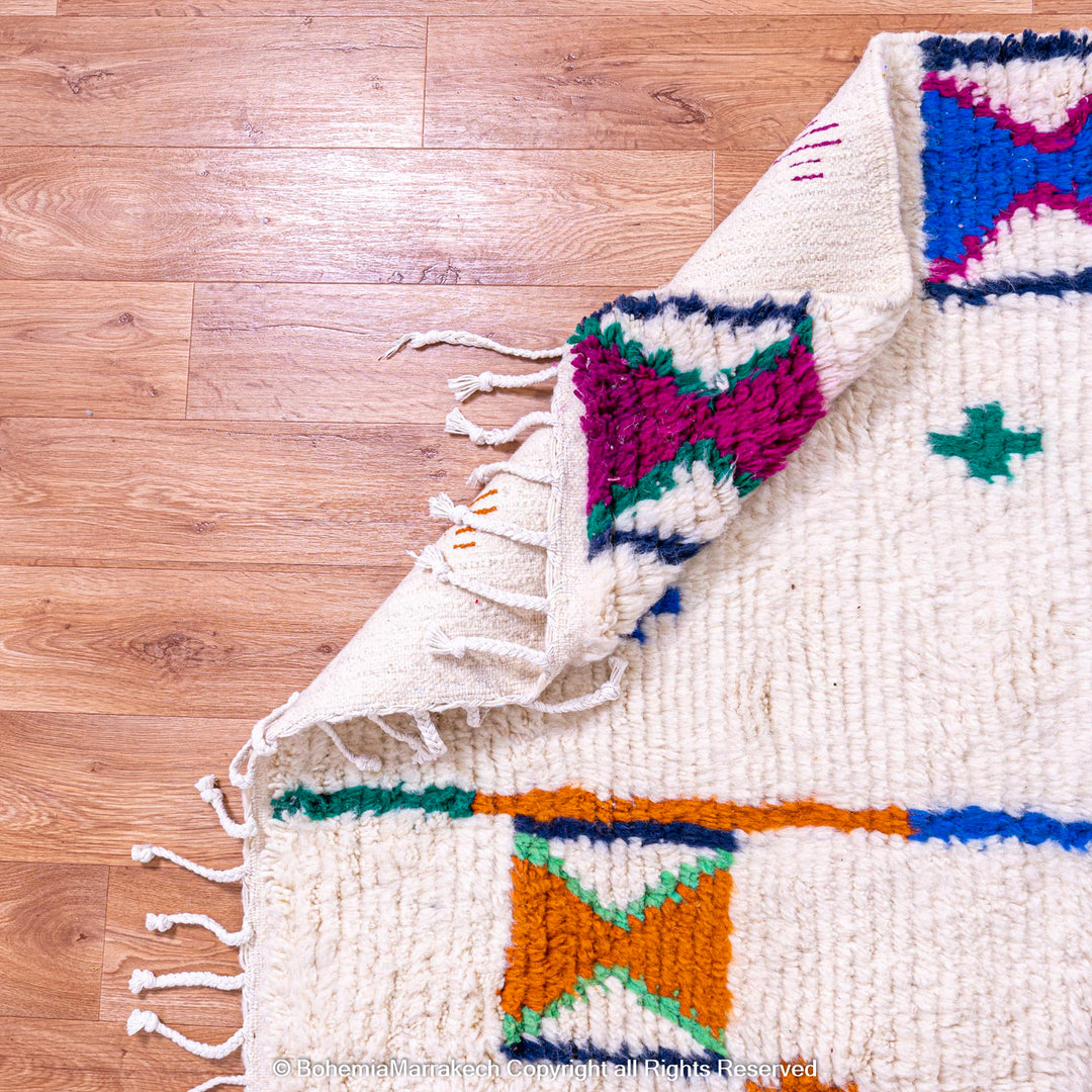 Colorful Moroccan Rug with Berber X and Cross Symbols, handwoven from natural wool, ideal for eclectic or artistic interiors.