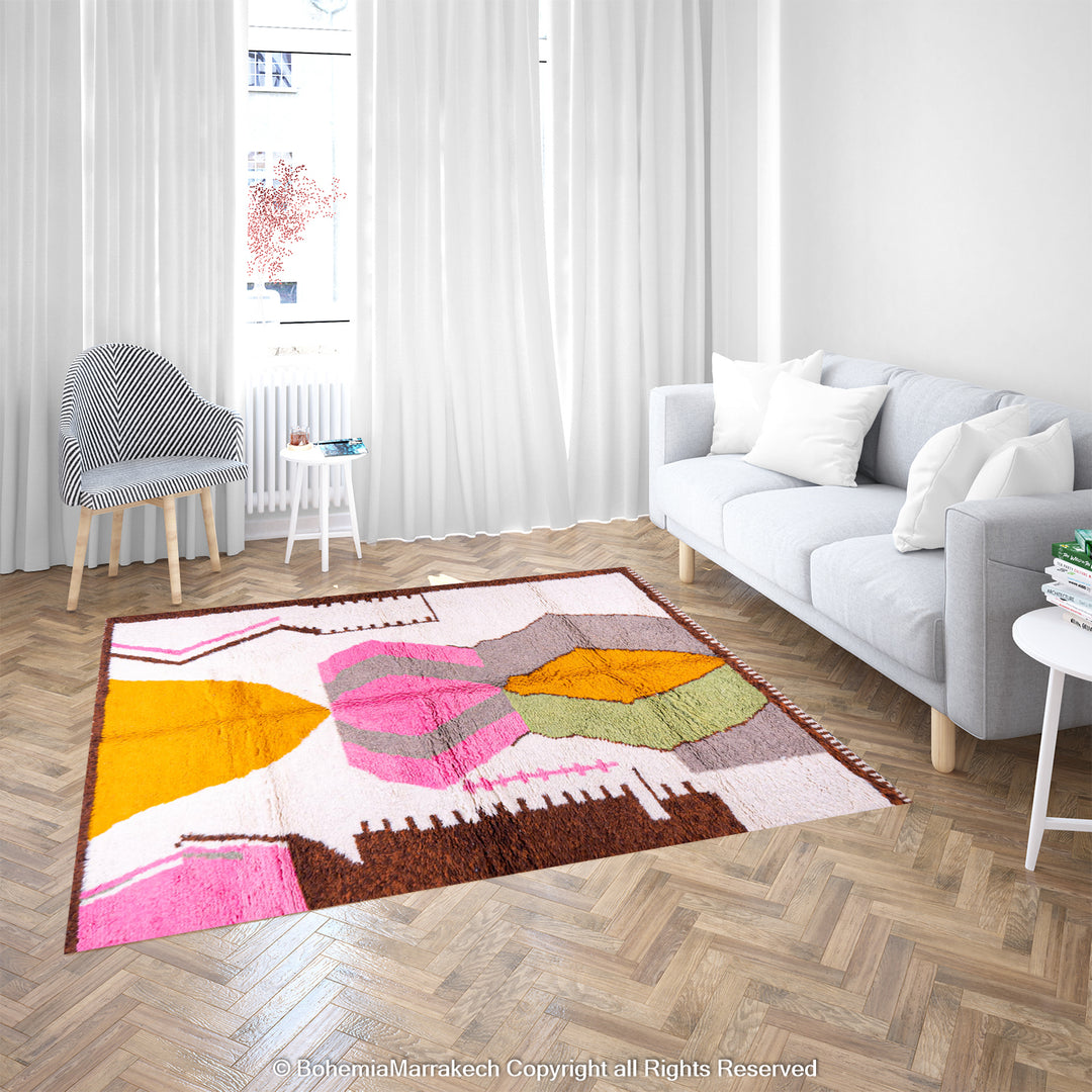 Handmade colorful Moroccan rug with pink, yellow, brown, and green geometric patterns on white wool