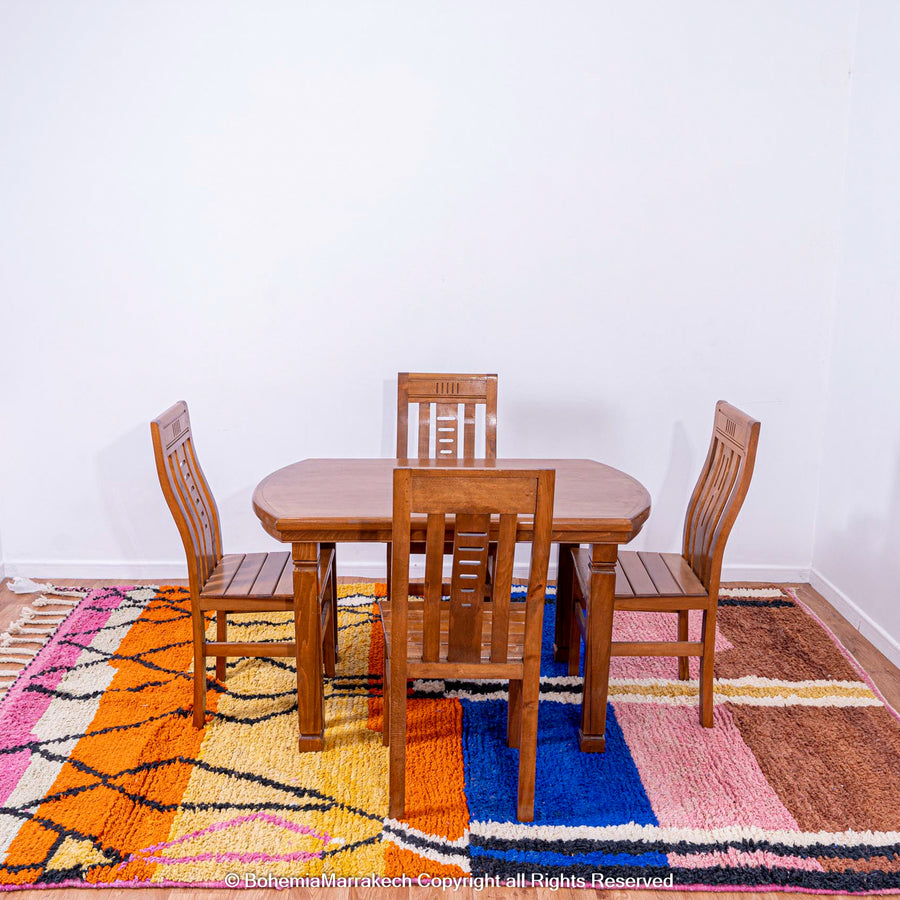 Handmade multicolor Moroccan wool rug with abstract geometric shapes in orange, blue, pink, and brown tones