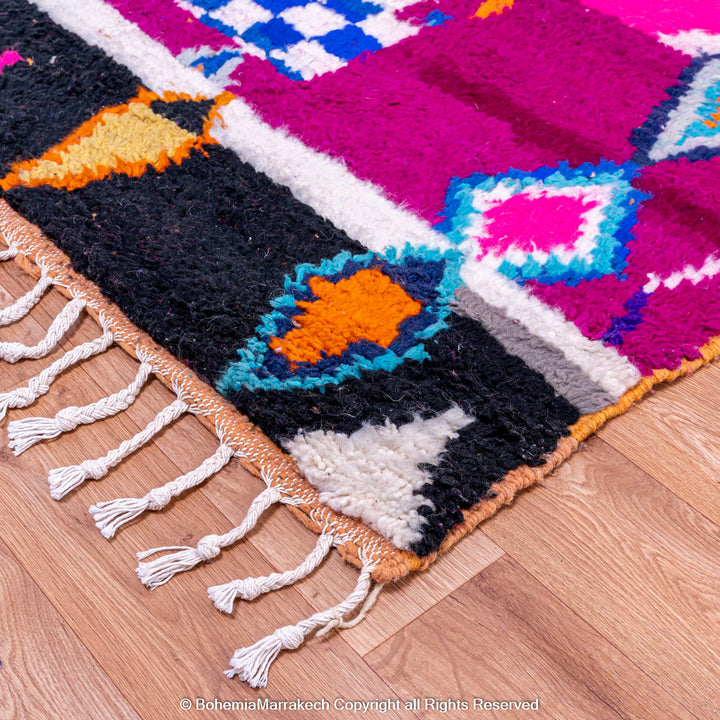 Pink abstract Moroccan wool rug with tribal and checkerboard motifs