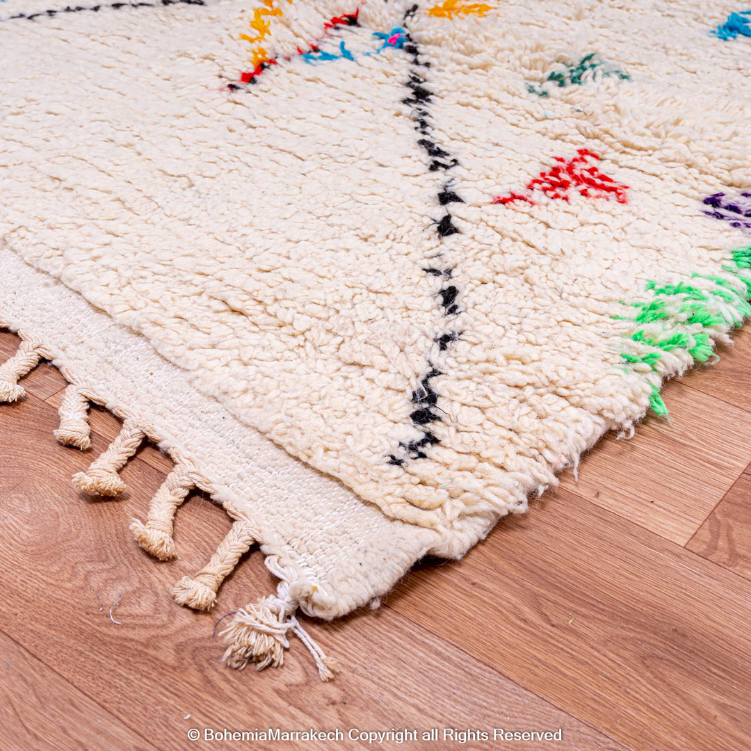 White Moroccan wool rug with multicolor tribal symbols and diamond pattern