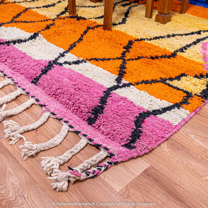 Handmade multicolor Moroccan wool rug with abstract geometric shapes in orange, blue, pink, and brown tones