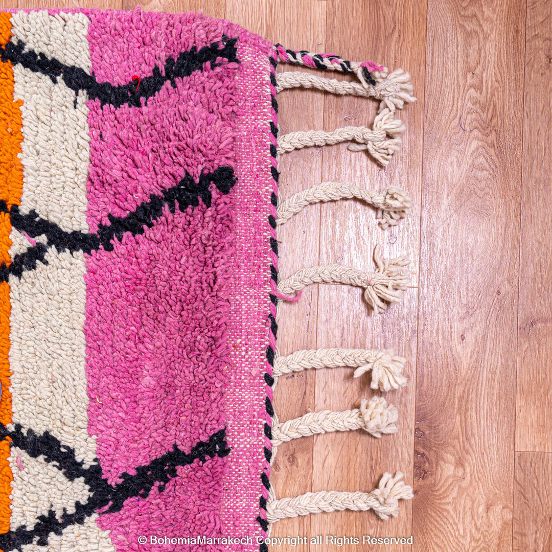 Handmade multicolor Moroccan wool rug with abstract geometric shapes in orange, blue, pink, and brown tones