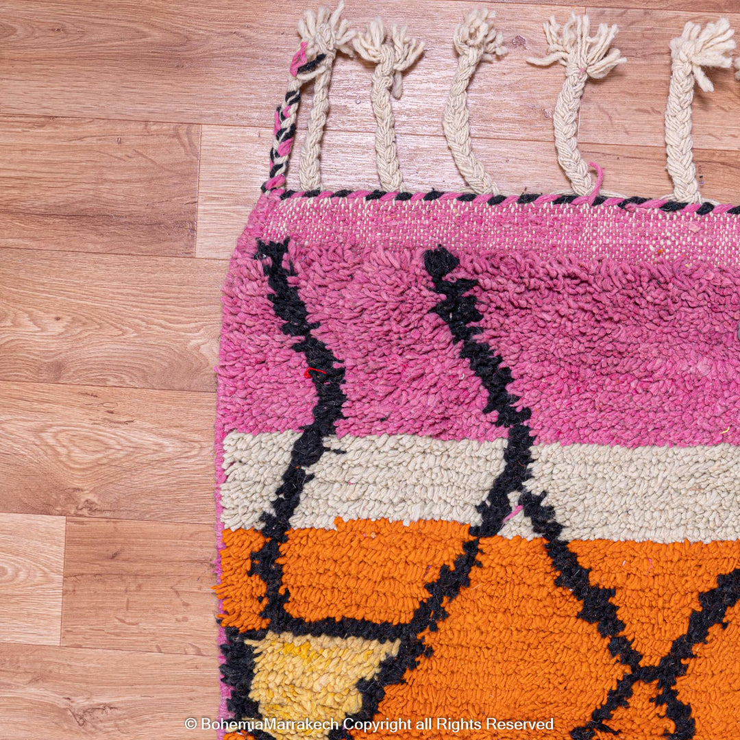 Handmade multicolor Moroccan wool rug with abstract geometric shapes in orange, blue, pink, and brown tones