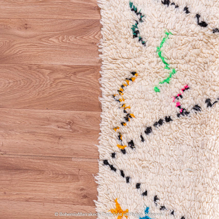 White Moroccan wool rug with multicolor tribal symbols and diamond pattern