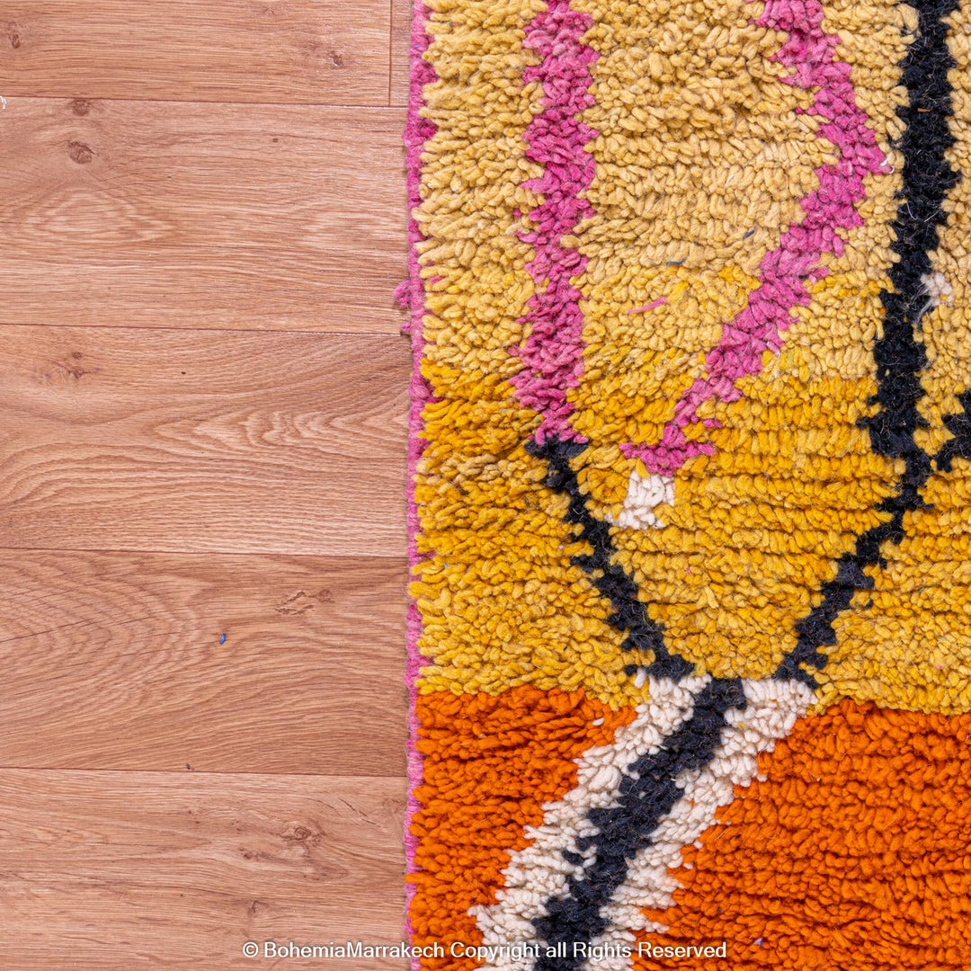 Handmade multicolor Moroccan wool rug with abstract geometric shapes in orange, blue, pink, and brown tones
