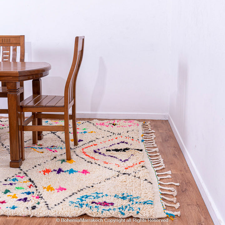 White Moroccan wool rug with multicolor tribal symbols and diamond pattern