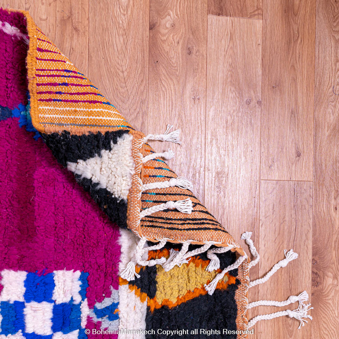 Pink abstract Moroccan wool rug with tribal and checkerboard motifs