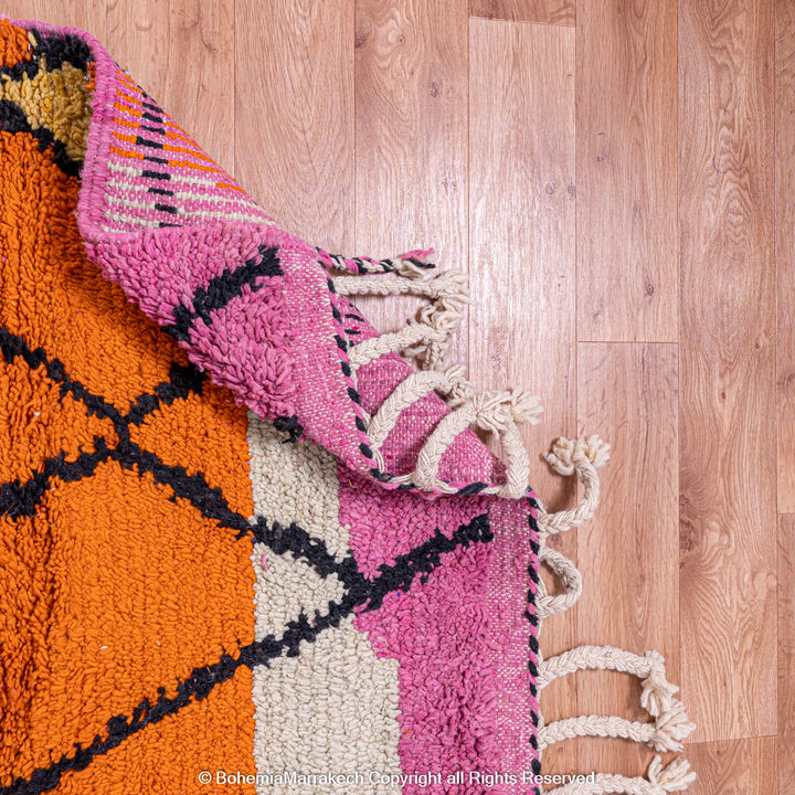 Handmade multicolor Moroccan wool rug with abstract geometric shapes in orange, blue, pink, and brown tones