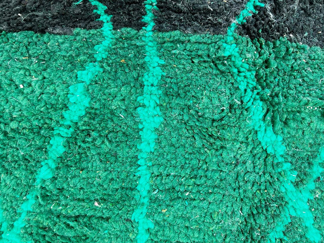 Emerald green Moroccan wool rug with diamond pattern, handmade by Berber artisans in Morocco