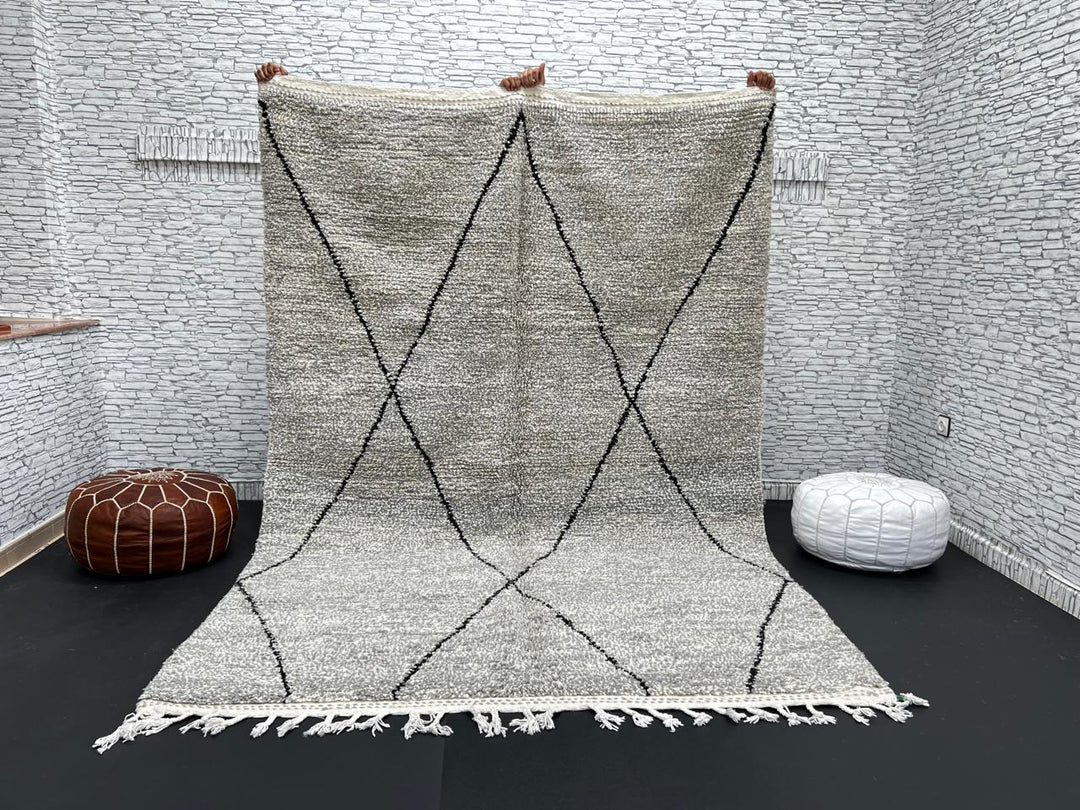 Handwoven gray Moroccan wool rug with black diamond pattern and fringes, handmade by Berber women in the Atlas Mountains