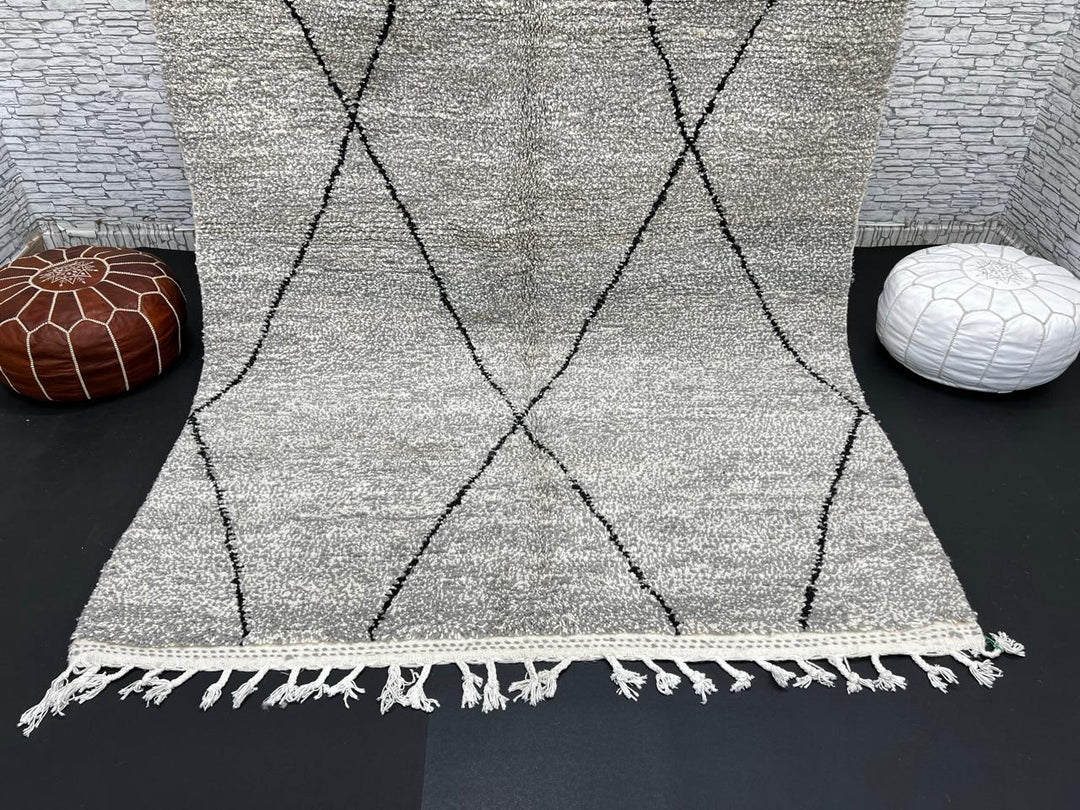 Handwoven gray Moroccan wool rug with black diamond pattern and fringes, handmade by Berber women in the Atlas Mountains