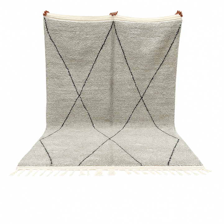Handwoven gray Moroccan wool rug with black diamond pattern and fringes, handmade by Berber women in the Atlas Mountains