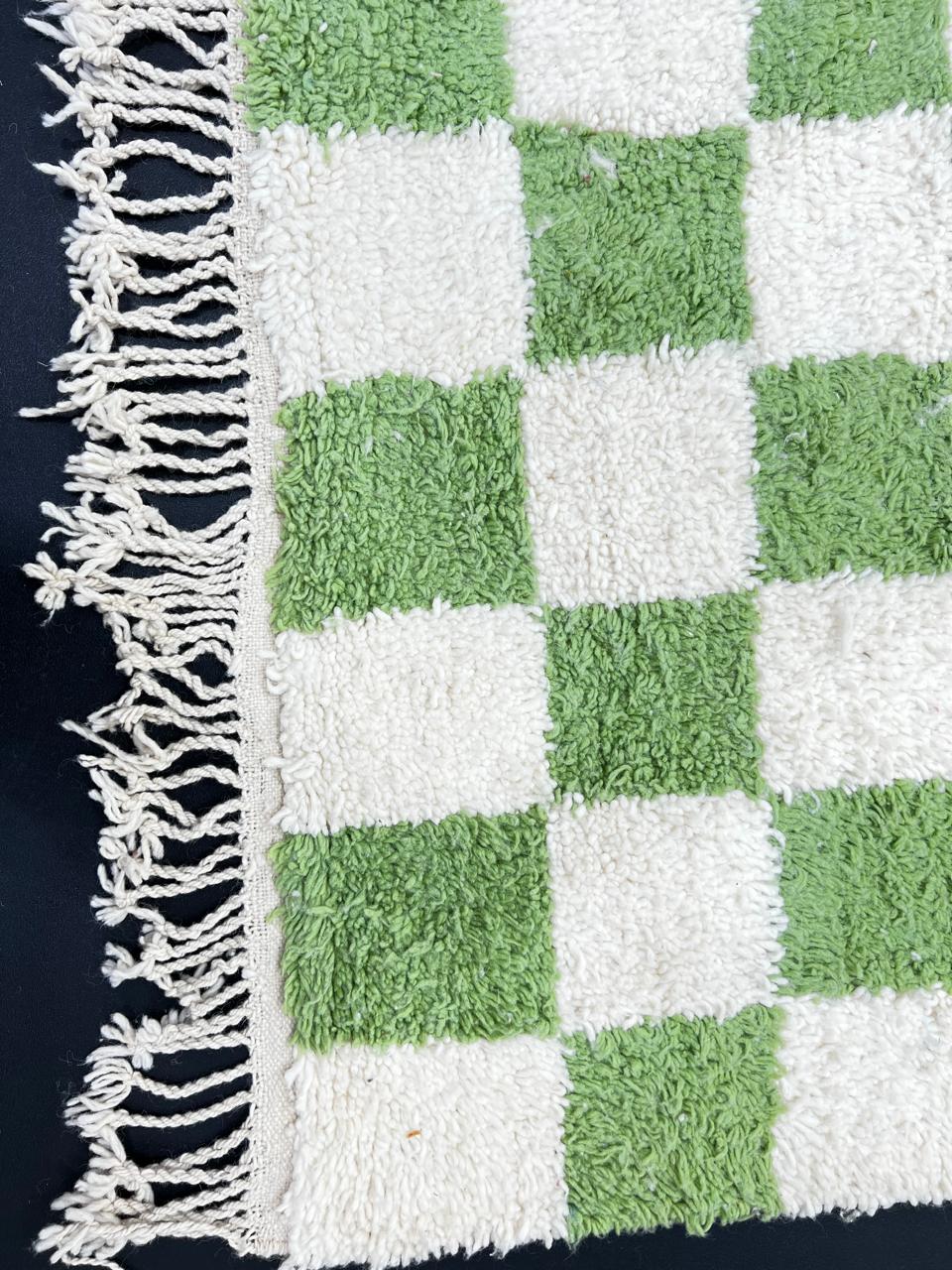 Handmade Moroccan runner rug with green and white checkerboard pattern, crafted from natural wool by Berber artisans.