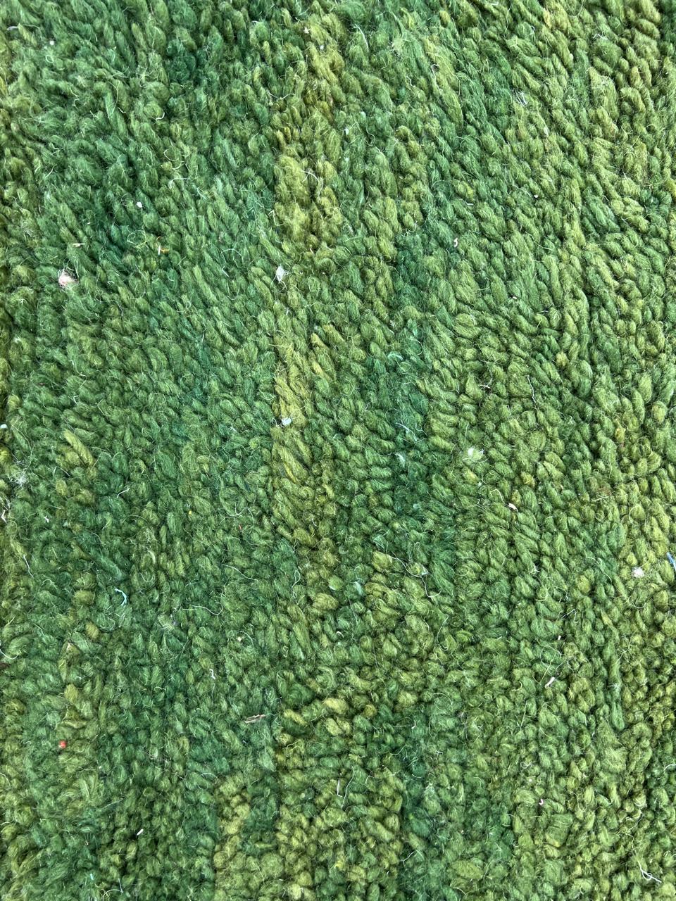 Handmade green Moroccan runner rug with white abstract linear design on natural wool.