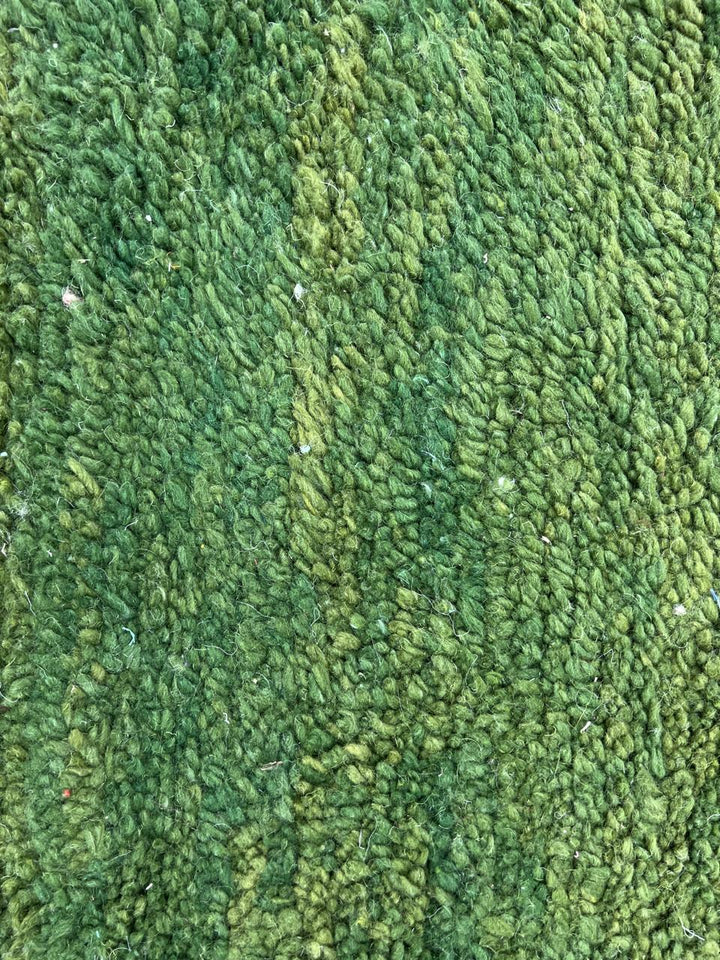 Handmade green Moroccan runner rug with white abstract linear design on natural wool.