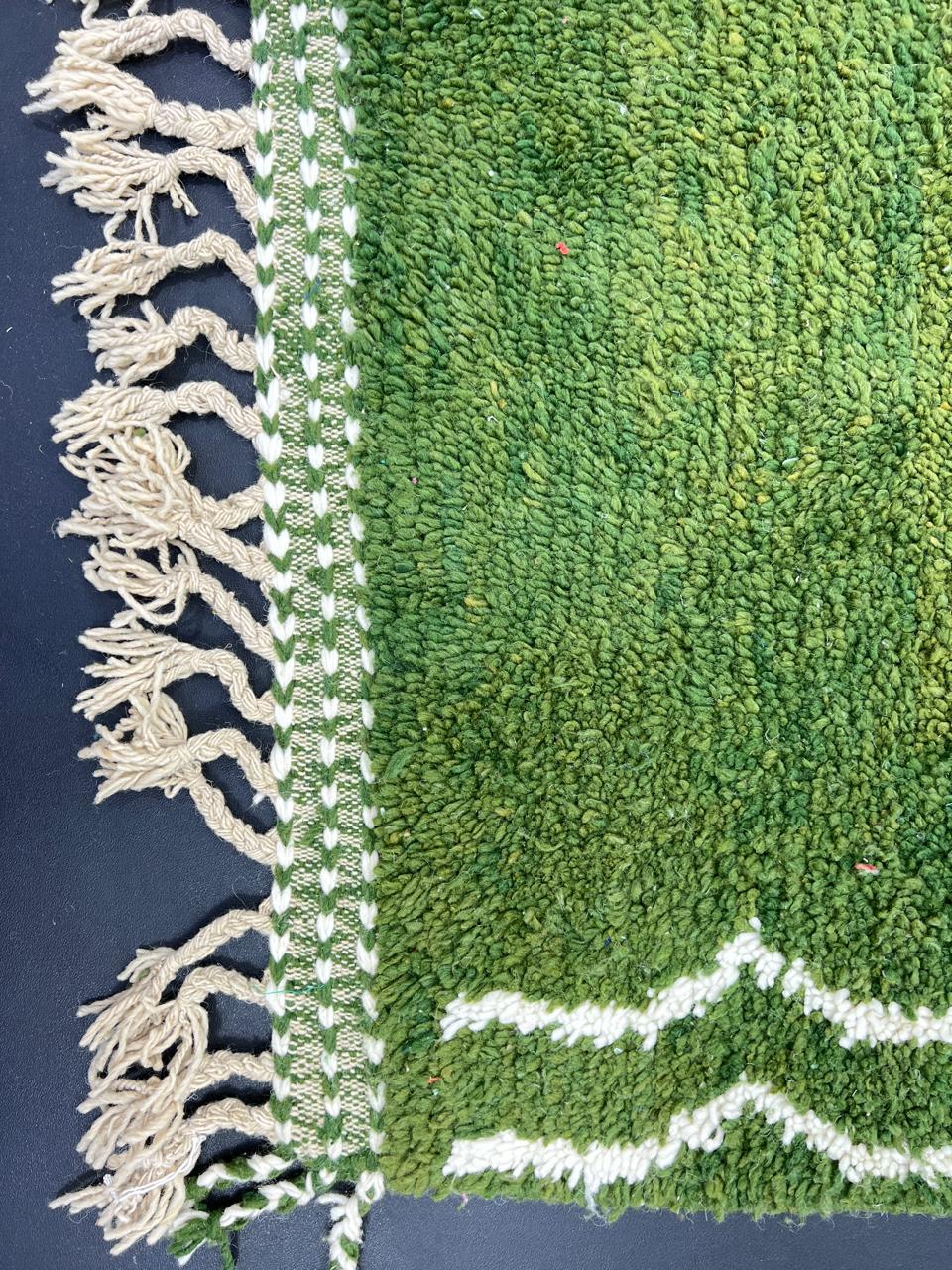 Handmade green Moroccan runner rug with white abstract linear design on natural wool.
