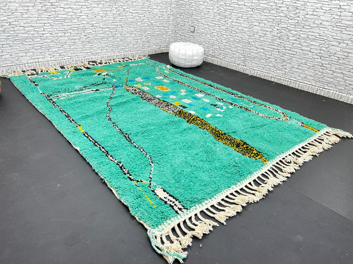 Green Moroccan wool rug with abstract geometric Berber pattern, handmade by artisans