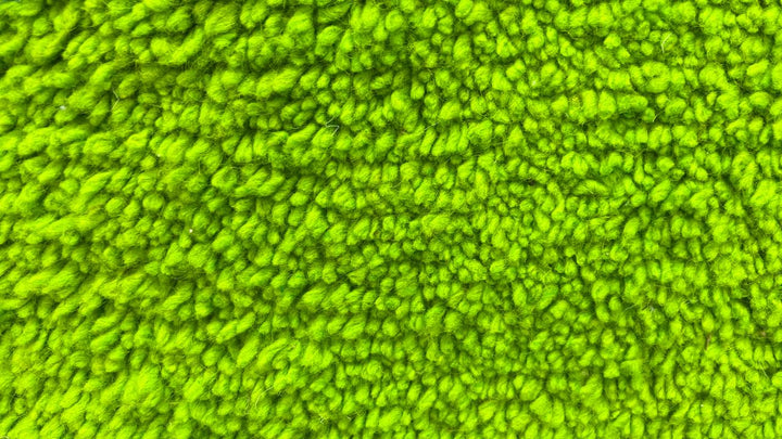 Solid green Moroccan wool rug with plush minimalist Berber texture