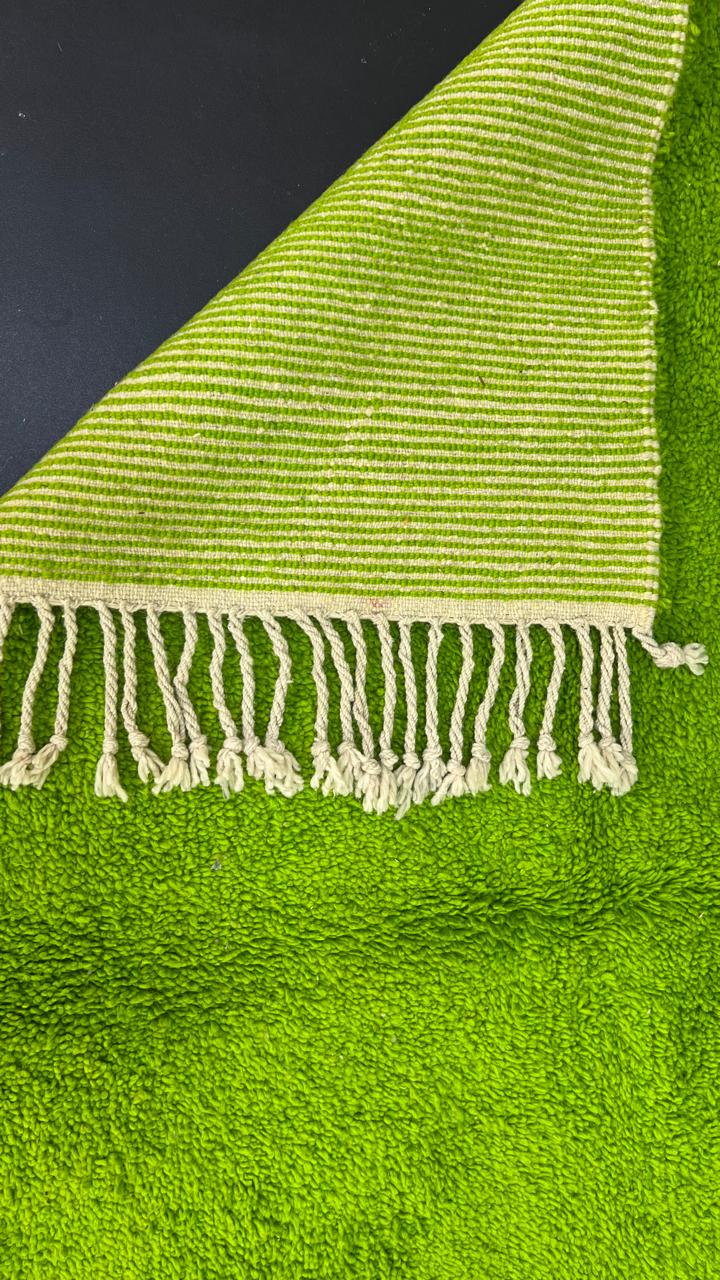 Solid green Moroccan wool rug with plush minimalist Berber texture