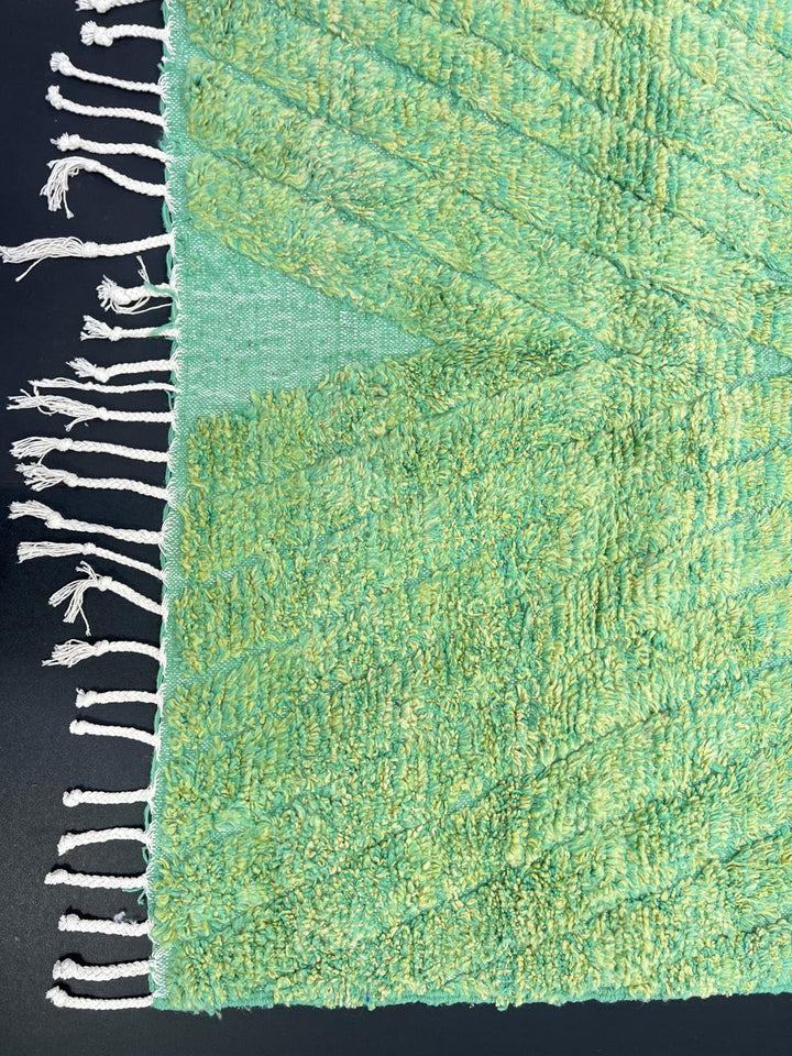 Green Moroccan wool rug with carved geometric lines and sculpted texture