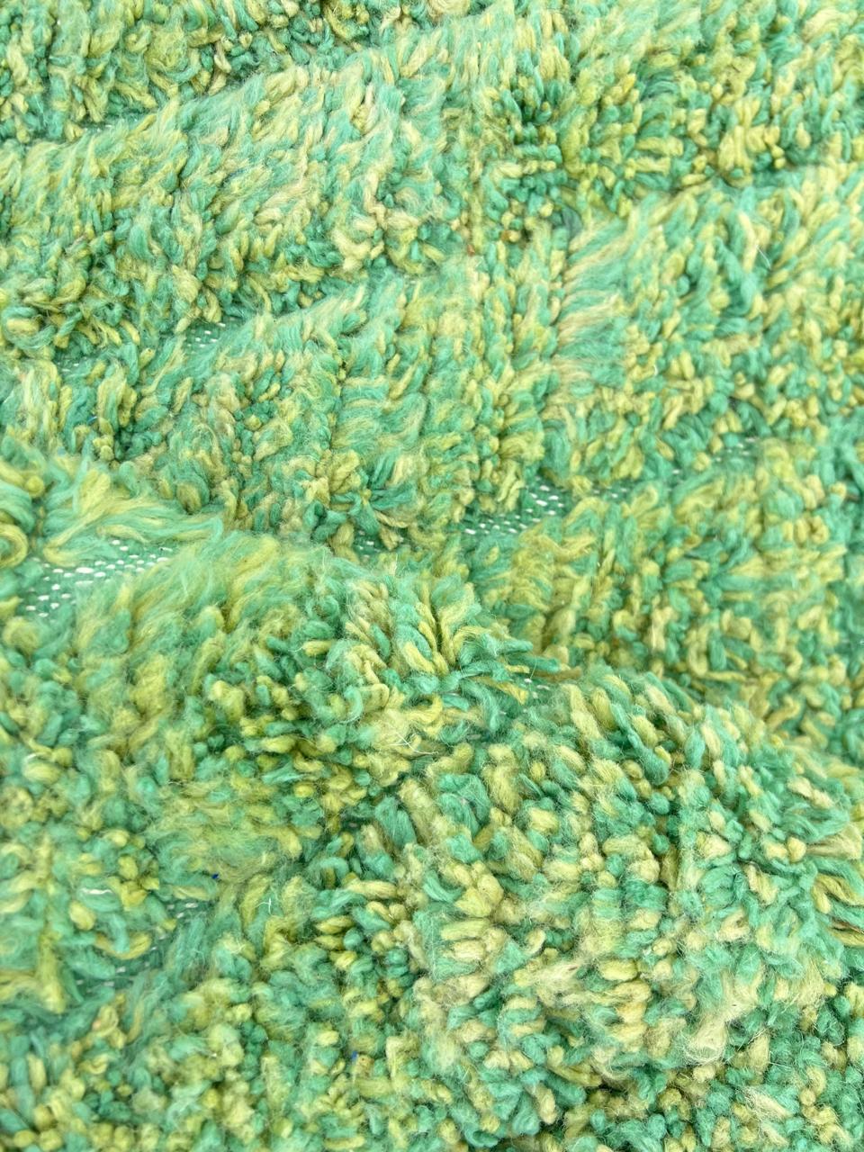 Green Moroccan wool rug with carved geometric lines and sculpted texture