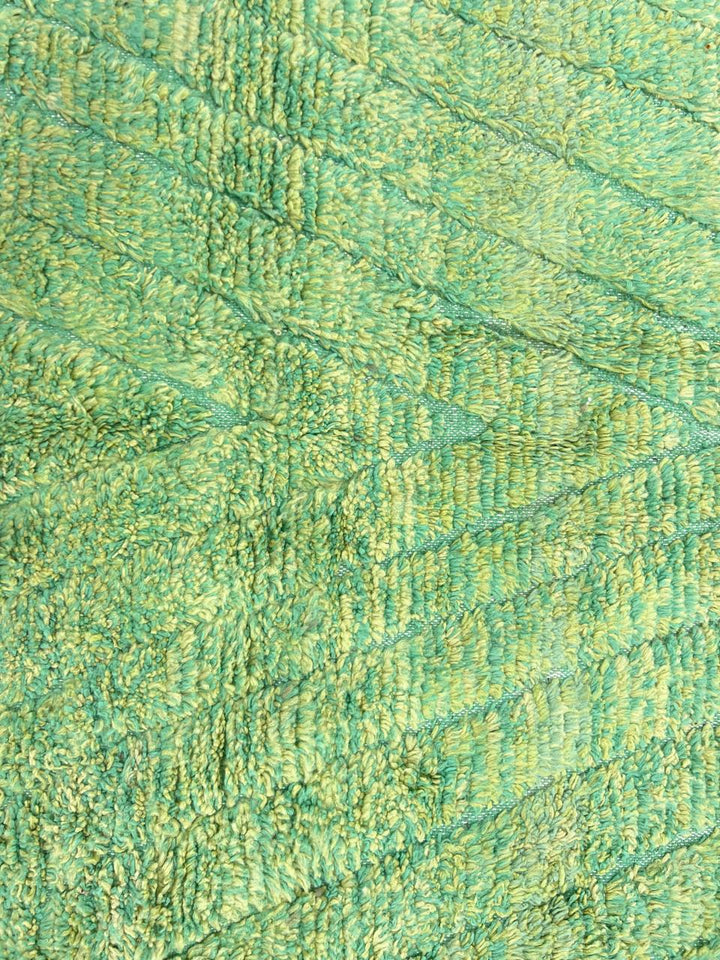 Green Moroccan wool rug with carved geometric lines and sculpted texture