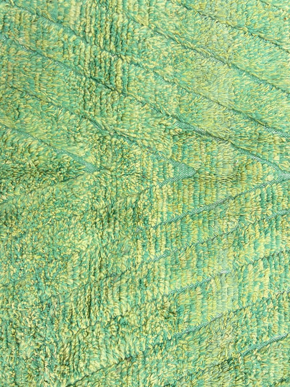 Green Moroccan wool rug with carved geometric lines and sculpted texture