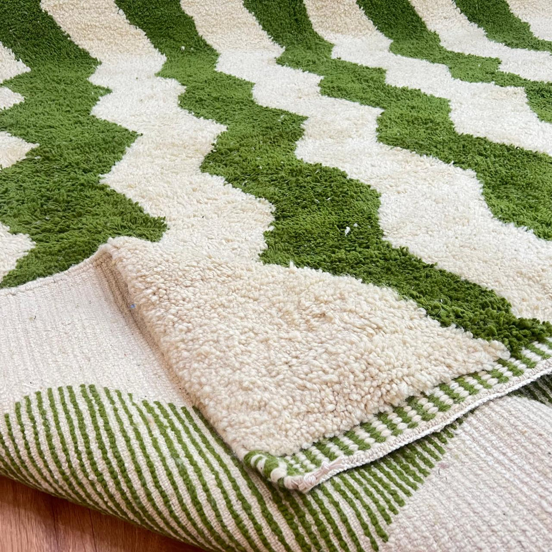 Green Moroccan wool runner rug with zigzag Berber pattern on ivory background, handmade chevron carpet