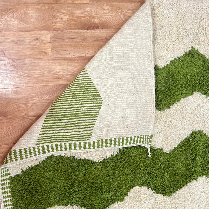 Green Moroccan wool runner rug with zigzag Berber pattern on ivory background, handmade chevron carpet