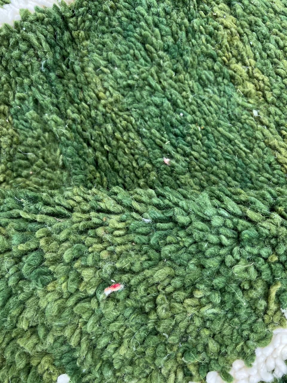 Green Moroccan round rug with white Berber line pattern, handmade wool.