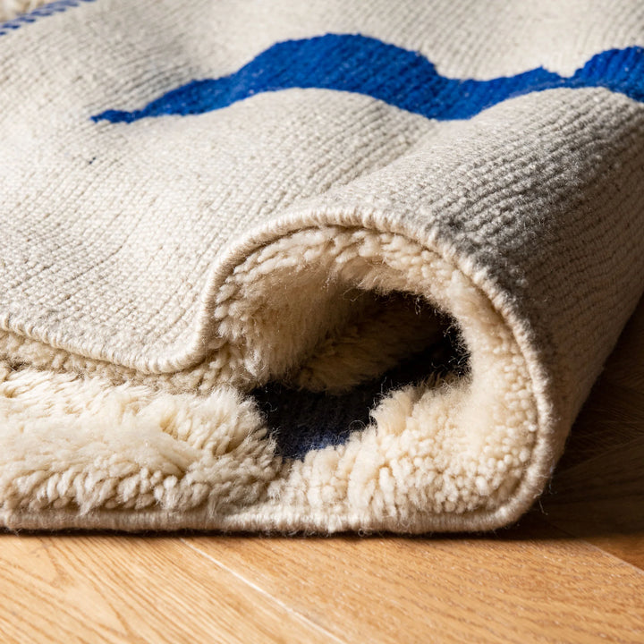 Handmade Beige Moroccan Rug with Abstract Blue Line Motifs
