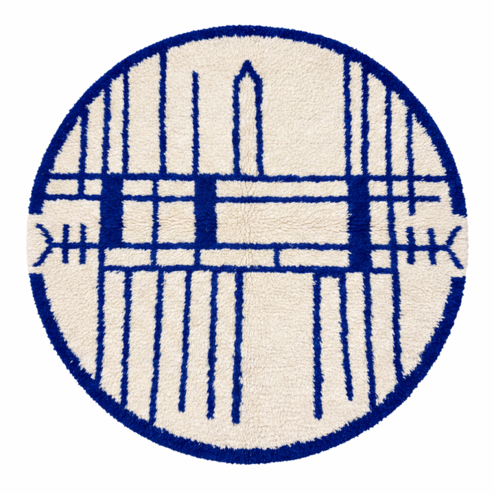 Handmade round Moroccan wool rug with blue Berber geometric pattern on ivory natural wool background