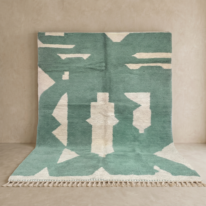 Handmade sage green Moroccan wool rug with ivory abstract geometric pattern and tassels
