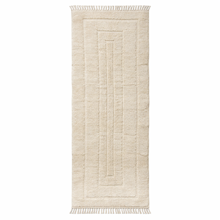 Handmade Moroccan wool runner rug in cream with raised carved geometric design and fringed ends